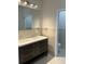 Bathroom featuring double sinks, a dark wood vanity, and tile flooring at 3391 Orchid Dr, Indian Lake Estates, FL 33855