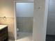 New bathroom with a shower room to the left and a stone tiled wall at 3391 Orchid Dr, Indian Lake Estates, FL 33855