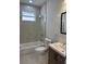 Bathroom featuring a tub-shower combo, a single sink vanity, and modern fixtures at 3391 Orchid Dr, Indian Lake Estates, FL 33855