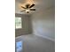 Modern bedroom with tile flooring, ceiling fan and great natural lighting at 3391 Orchid Dr, Indian Lake Estates, FL 33855