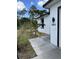 This new construction home includes dark trim around the windows and a freshly planted garden at 3391 Orchid Dr, Indian Lake Estates, FL 33855