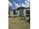 New construction home with a modern design featuring black window frames and freshly landscaped lawn at 3391 Orchid Dr, Indian Lake Estates, FL 33855