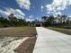 New construction home features a long driveway, an attached garage, and front yard at 3391 Orchid Dr, Indian Lake Estates, FL 33855