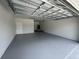 Spacious two car garage with sealed floor, bright lighting and tall ceilings at 3391 Orchid Dr, Indian Lake Estates, FL 33855
