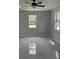 Bright living room with tile flooring, natural light, and a modern ceiling fan at 3391 Orchid Dr, Indian Lake Estates, FL 33855
