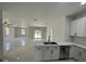 Living space view to kitchen featuring stainless steel appliances and sliding doors at 3391 Orchid Dr, Indian Lake Estates, FL 33855