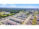 Expansive aerial view showcasing a well-planned community with modern homes and lush green spaces in a scenic area at 4063 Roaming Brook Dr, Apopka, FL 32712