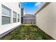Small grassy backyard area with minimal landscaping, fenced for privacy and pet safety at 4063 Roaming Brook Dr, Apopka, FL 32712
