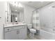 Bright bathroom featuring a large mirror, modern vanity, and shower/tub combo with stylish fixtures and finishes at 4063 Roaming Brook Dr, Apopka, FL 32712