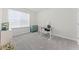 Bright bedroom featuring neutral tones, a comfortable desk, and a large window providing natural light at 4063 Roaming Brook Dr, Apopka, FL 32712