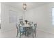 Bright dining area with natural light and a modern light fixture is the perfect space for dinner at 4063 Roaming Brook Dr, Apopka, FL 32712