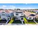 The front exterior of two-story home has a covered porch, manicured landscaping, and green lawn at 4063 Roaming Brook Dr, Apopka, FL 32712