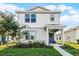 Charming two-story home featuring a welcoming front porch, beautiful landscaping, and a freshly painted exterior at 4063 Roaming Brook Dr, Apopka, FL 32712