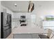 Bright kitchen features white cabinets, stainless steel appliances, and a large island with quartz countertops at 4063 Roaming Brook Dr, Apopka, FL 32712