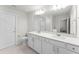 Clean main bathroom with double vanity, modern fixtures, framed mirror, and glass-enclosed shower at 4063 Roaming Brook Dr, Apopka, FL 32712