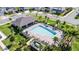An aerial view of the community pool with ample seating, lush landscaping, and a covered pavilion area at 4063 Roaming Brook Dr, Apopka, FL 32712