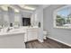 Bathroom with a double sink vanity, stylish cabinets, and wood look flooring, providing modern comfort at 409 Jumper S Dr, Bushnell, FL 33513