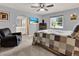 Bedroom boasting a comfy chair, ceiling fan, and a view to an adjoining bathroom at 409 Jumper S Dr, Bushnell, FL 33513