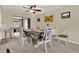 Bright dining room with a large dining table, neutral decor, and a view of the living room at 409 Jumper S Dr, Bushnell, FL 33513