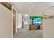 Inviting entryway featuring a view into the open living area, a beach scene on the television, and neutral decor at 409 Jumper S Dr, Bushnell, FL 33513