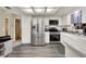 Modern kitchen features stainless steel appliances, white cabinets, and wood-look flooring at 409 Jumper S Dr, Bushnell, FL 33513