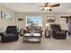 Cozy living room featuring comfortable leather seating, neutral carpeting, and lots of natural light at 409 Jumper S Dr, Bushnell, FL 33513