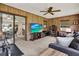 Comfortable living room with ceiling fan, home entertainment center, and sliding doors to another room at 409 Jumper S Dr, Bushnell, FL 33513