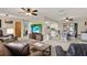 Open-concept living space with a living room, dining area, and a peek into the kitchen at 409 Jumper S Dr, Bushnell, FL 33513