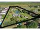 Expansive aerial view of a home with a private pond and lush greenery, highlighting the serene landscape at 4121 High Plains Ln, Kissimmee, FL 34744