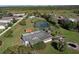 Aerial view of the home and the large treed lot featuring a serene pond. The back of the house can be seen at 4121 High Plains Ln, Kissimmee, FL 34744