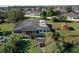 This aerial view shows the back of the property with a wooden deck, shed and a large treed area at 4121 High Plains Ln, Kissimmee, FL 34744
