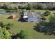 Aerial shot of the house's backyard, including a tranquil pond, and wooden shed and deck at 4121 High Plains Ln, Kissimmee, FL 34744