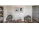 Cozy living room with neutral walls, two chairs, small tables and light-colored carpeting at 4258 Eastminster Rd, Davenport, FL 33837