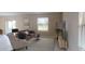 Bright living room with large window, a sliding glass door and neutral-colored furniture at 4258 Eastminster Rd, Davenport, FL 33837