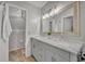 Bathroom featuring a double vanity with marble countertop and decorative mirror at 4306 Lake Underhill Rd # C, Orlando, FL 32803