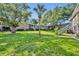 Exterior showing landscaped yard, mature palm tree, brick walkway, and building exterior at 4306 Lake Underhill Rd # C, Orlando, FL 32803
