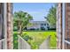 Courtyard view showing lush lawn, mature palm tree, brick walkway, and exterior at 4306 Lake Underhill Rd # C, Orlando, FL 32803