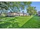 Well-maintained brick apartment building with a spacious lawn and mature trees in a serene setting at 4306 Lake Underhill Rd # C, Orlando, FL 32803