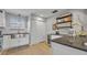 Modern kitchen featuring a stainless steel sink, granite countertops, floating shelves and a wine cooler at 4306 Lake Underhill Rd # C, Orlando, FL 32803