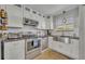 Well-lit kitchen featuring stainless steel appliances, ample countertop space, and a view of the exterior at 4306 Lake Underhill Rd # C, Orlando, FL 32803