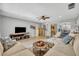 Open-concept living room with modern furnishings, wood floors, ceiling fan, and great views of the kitchen at 4306 Lake Underhill Rd # C, Orlando, FL 32803