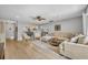 Spacious living room featuring sleek furnishings, wood floors, and an open layout with sightlines to the dining area at 4306 Lake Underhill Rd # C, Orlando, FL 32803