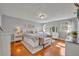 Bright main bedroom with wood floors, two windows, light grey paint, and white furniture at 4306 Lake Underhill Rd # C, Orlando, FL 32803
