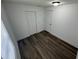 This bedroom features new hardwood floors, white walls and updated lighting at 506 South St, Daytona Beach, FL 32114