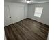 Cozy bedroom with wood-look flooring, closet, and natural light from the window at 506 South St, Daytona Beach, FL 32114