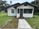 Charming single-story home features a screened porch and newly landscaped walkway to the front door at 506 South St, Daytona Beach, FL 32114