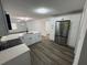 Open kitchen featuring stainless steel appliances, white cabinetry, and stone countertops at 506 South St, Daytona Beach, FL 32114