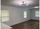 Open-concept living room features hardwood floors and modern lighting fixtures at 506 South St, Daytona Beach, FL 32114