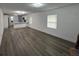 Open living space with wood-look floors and view of the kitchen with bar top at 506 South St, Daytona Beach, FL 32114
