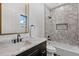 Modern bathroom featuring marble countertops, stylish fixtures, and a tiled shower/bath combo at 5237 Haverill Dr, Orlando, FL 32809